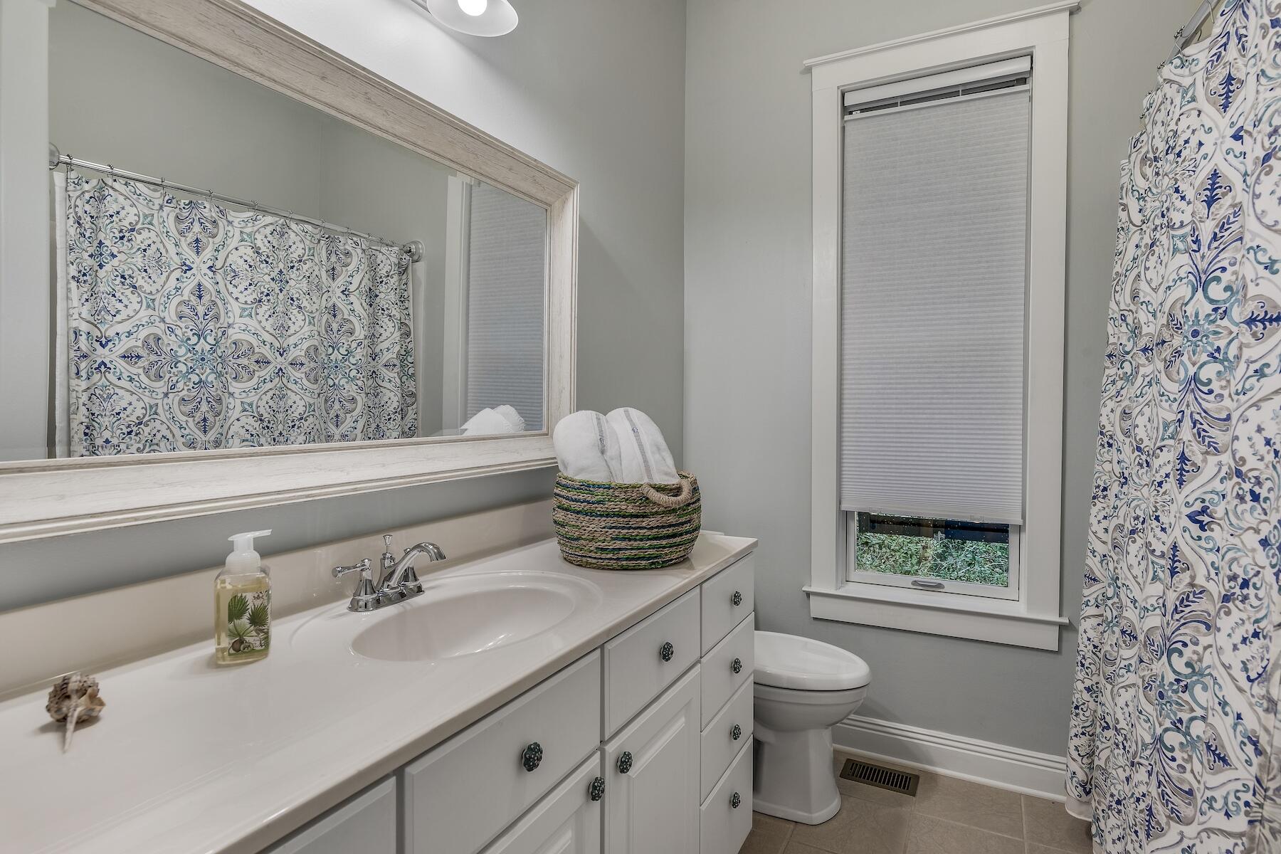304 Wilderness Way Santa Rosa Beach, FL 32459 - Photo 38 of 48 a bathroom with a granite countertop sink a toilet and a shower curtain