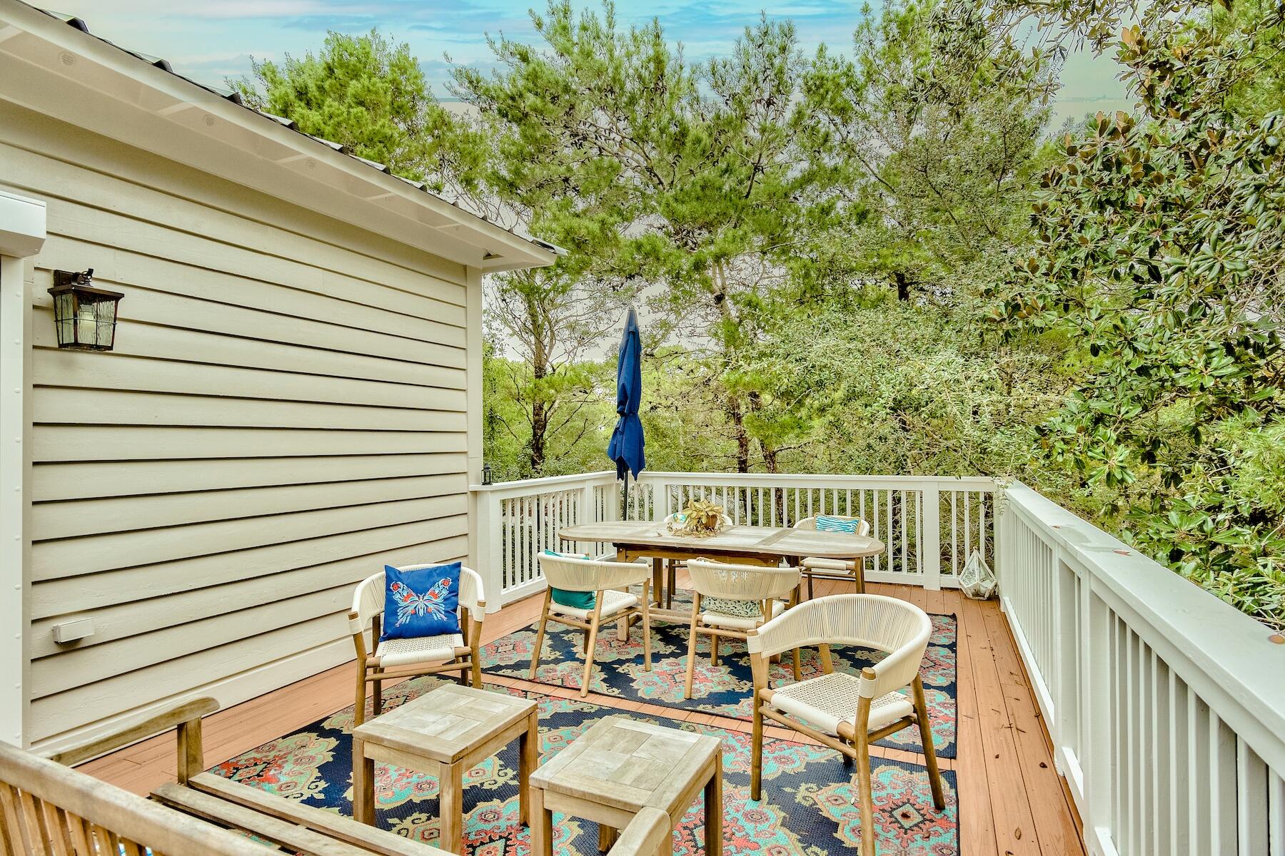 304 Wilderness Way Santa Rosa Beach, FL 32459 - Photo 40 of 48 a balcony with furniture and wooden floor