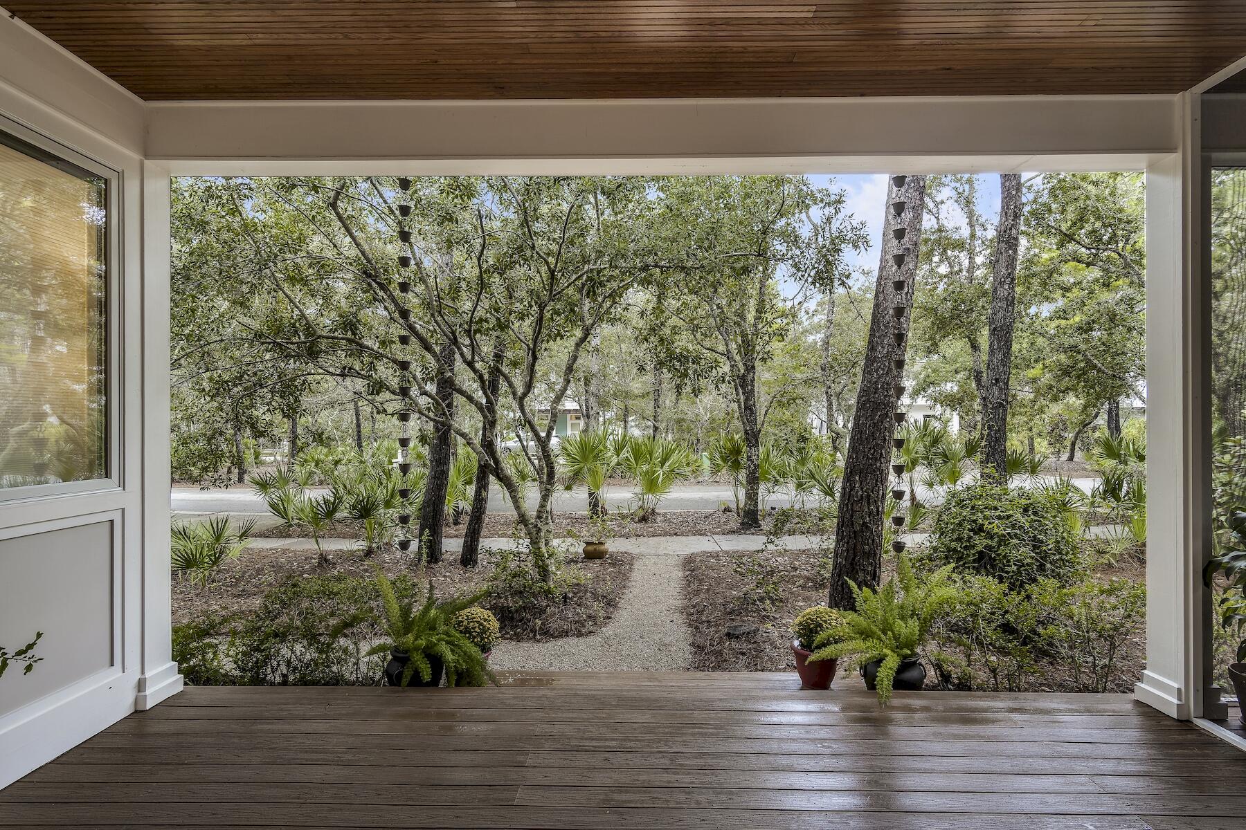 304 Wilderness Way Santa Rosa Beach, FL 32459 - Photo 4 of 48 a view of a garden with plants and large trees
