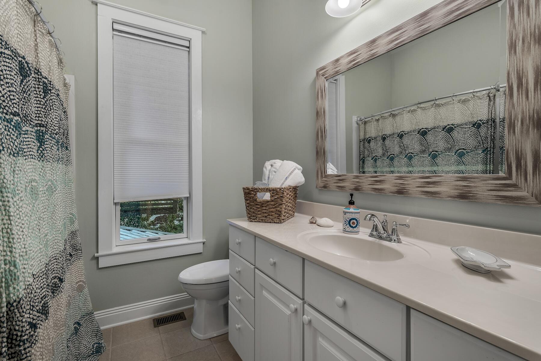 304 Wilderness Way Santa Rosa Beach, FL 32459 - Photo 44 of 48 a bathroom with a toilet sink and mirror