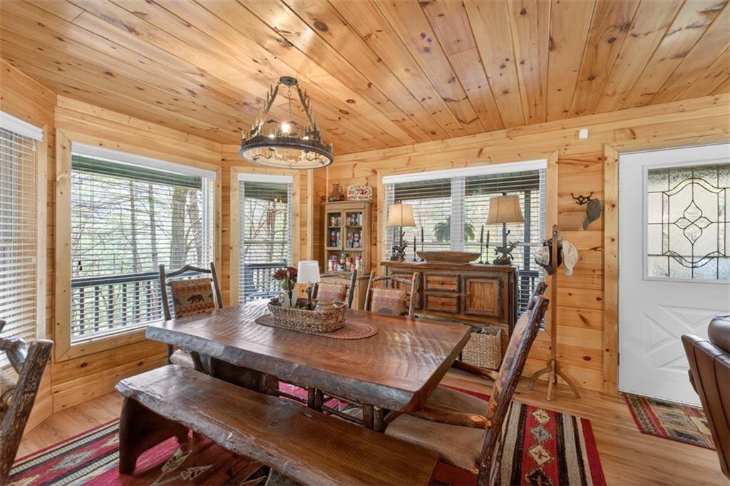 88 Crest Road Blairsville, GA 30512 - Photo 11 of 75 a view of a dining room with furniture wooden floor and chandelier