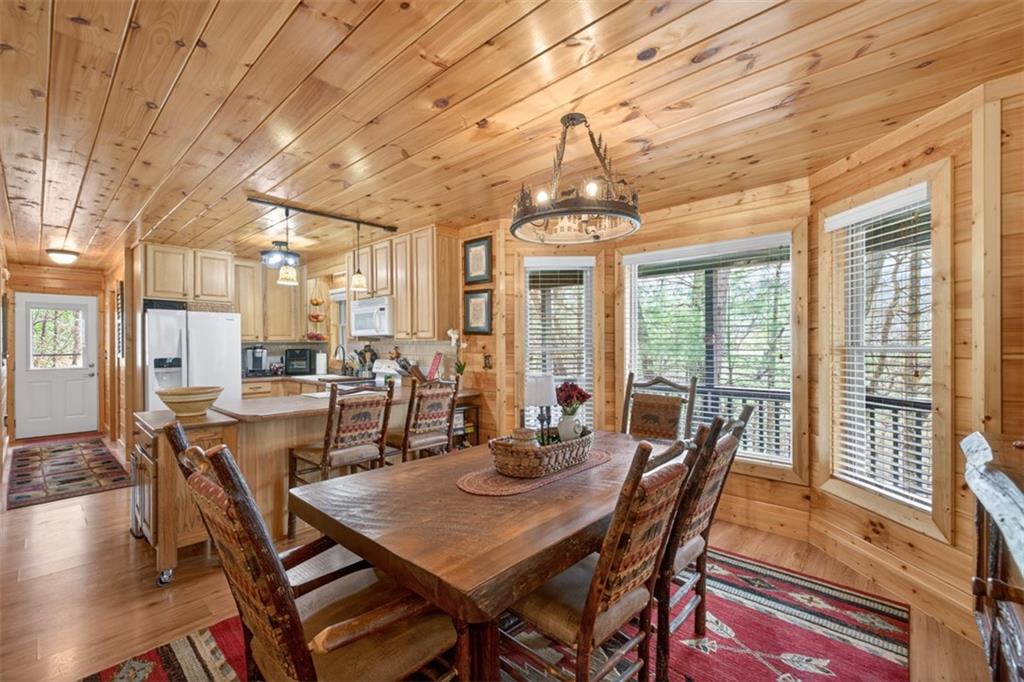 88 Crest Road Blairsville, GA 30512 - Photo 12 of 75 a view of a dining room with furniture wooden floor and chandelier