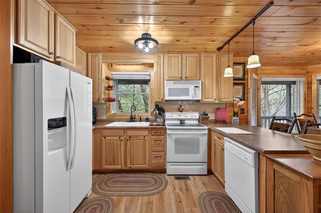 88 Crest Road Blairsville, GA 30512 - Photo 15 of 75 a kitchen with white cabinets and white appliances