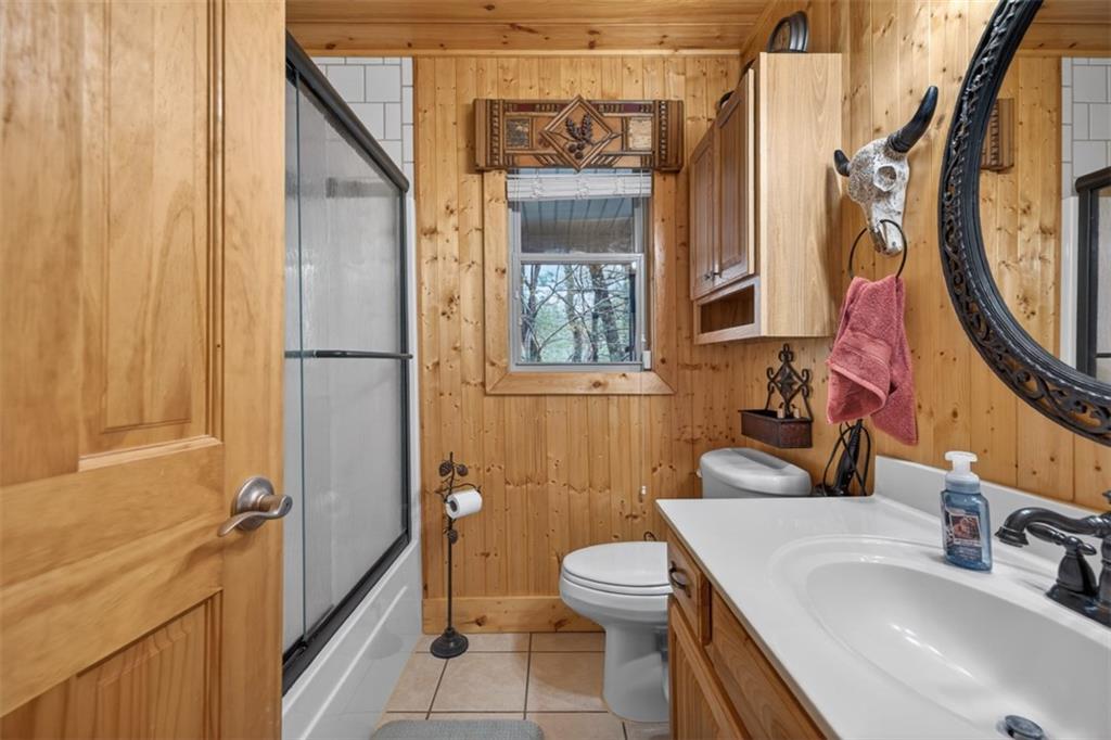 88 Crest Road Blairsville, GA 30512 - Photo 20 of 75 a bathroom with a sink a toilet and a mirror