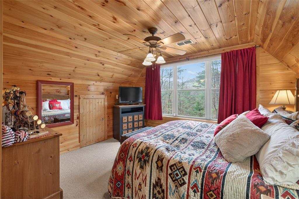 88 Crest Road Blairsville, GA 30512 - Photo 23 of 75 a bed sitting in a bedroom next to a window