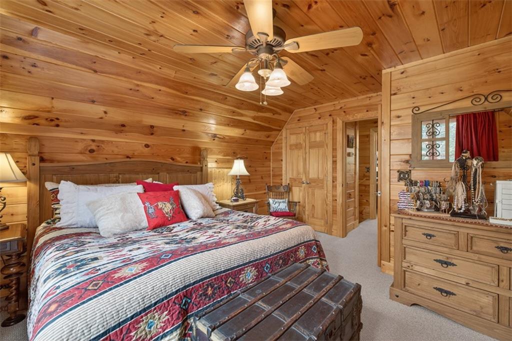 88 Crest Road Blairsville, GA 30512 - Photo 24 of 75 a bedroom with a bed and with the view of chandelier