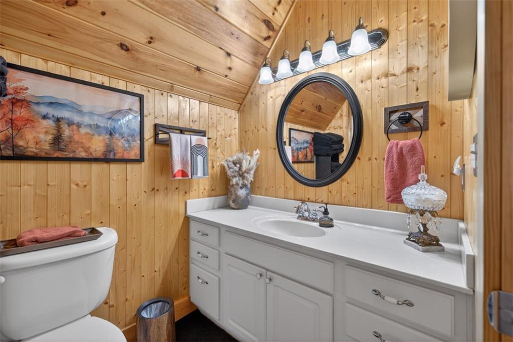 88 Crest Road Blairsville, GA 30512 - Photo 25 of 75 a bathroom with a toilet sink and mirror