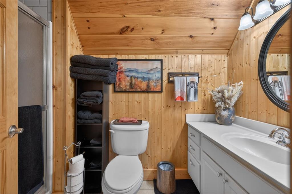 88 Crest Road Blairsville, GA 30512 - Photo 26 of 75 a bathroom with a toilet a sink and mirror