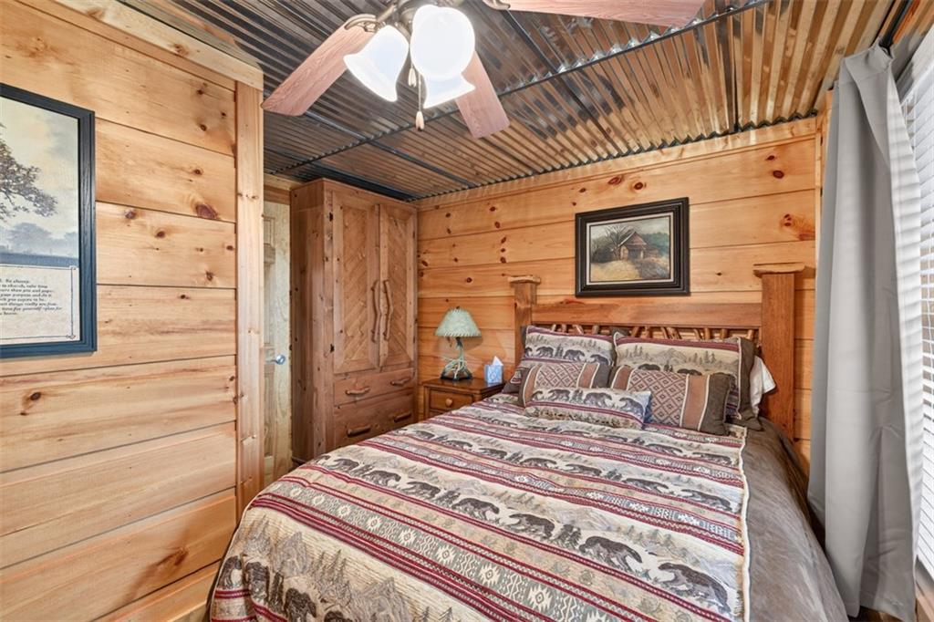 88 Crest Road Blairsville, GA 30512 - Photo 35 of 75 a bedroom with a bed a dresser and a window