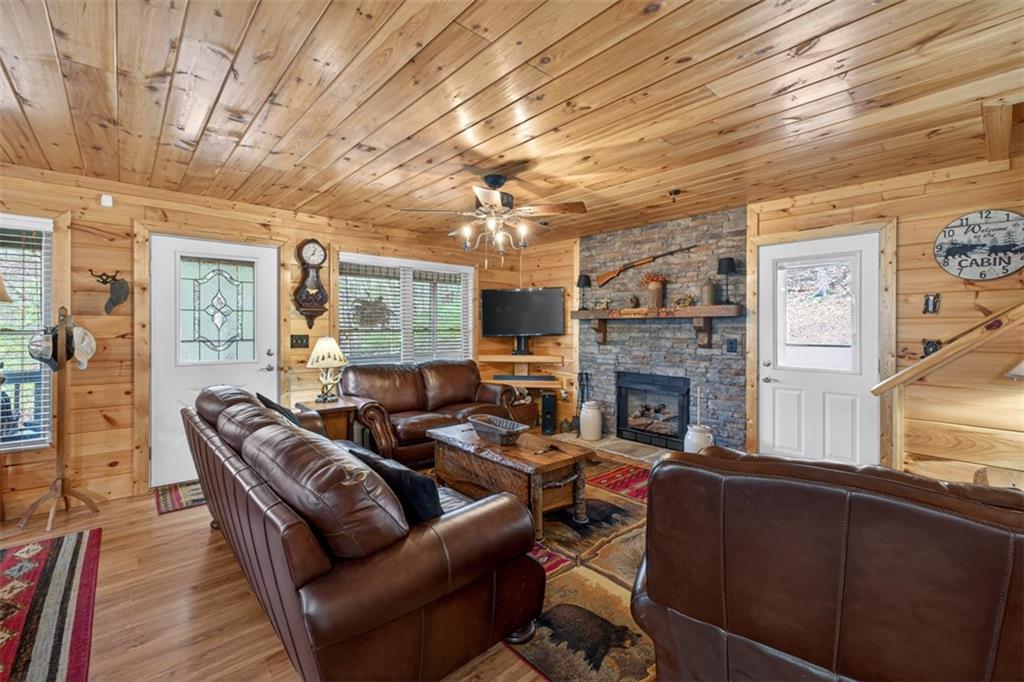 88 Crest Road Blairsville, GA 30512 - Photo 4 of 75 a living room with furniture a fireplace and a flat screen tv