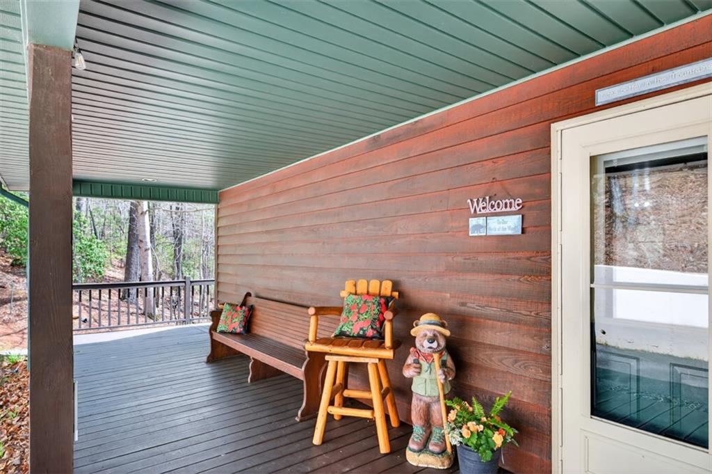 88 Crest Road Blairsville, GA 30512 - Photo 50 of 75 a backyard of a house with wooden floor chairs and outdoor seating