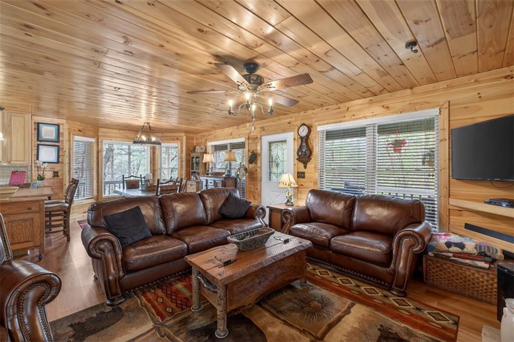 88 Crest Road Blairsville, GA 30512 - Photo 6 of 75 a living room with furniture a flat screen tv and a dining table
