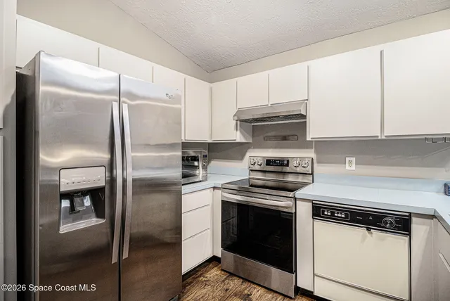 a kitchen with a refrigerator sink and microwave