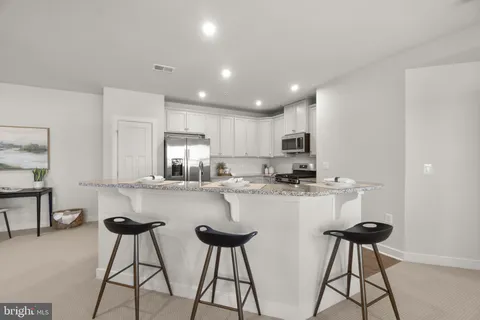 a kitchen with stainless steel appliances a refrigerator and a stove top oven