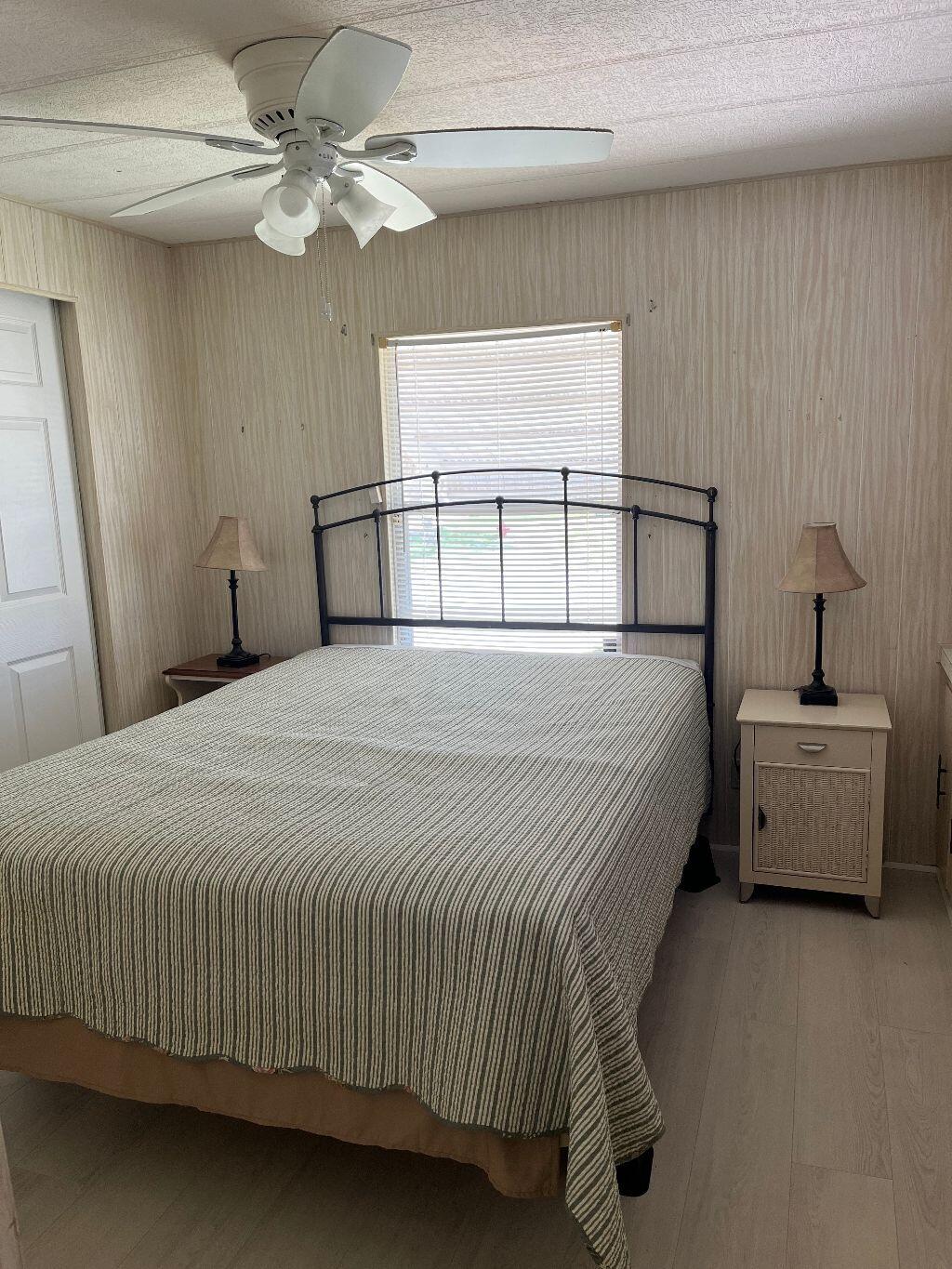 6948 Southeast Delegate Street Hobe Sound, FL 33455 - Photo 11 of 17 a bedroom with a bed and a window