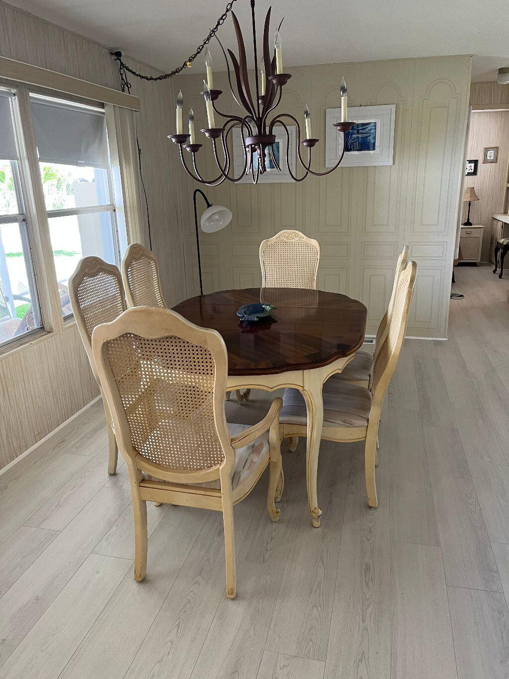 6948 Southeast Delegate Street Hobe Sound, FL 33455 - Photo 5 of 17 a view of a dining room with furniture and wooden floor
