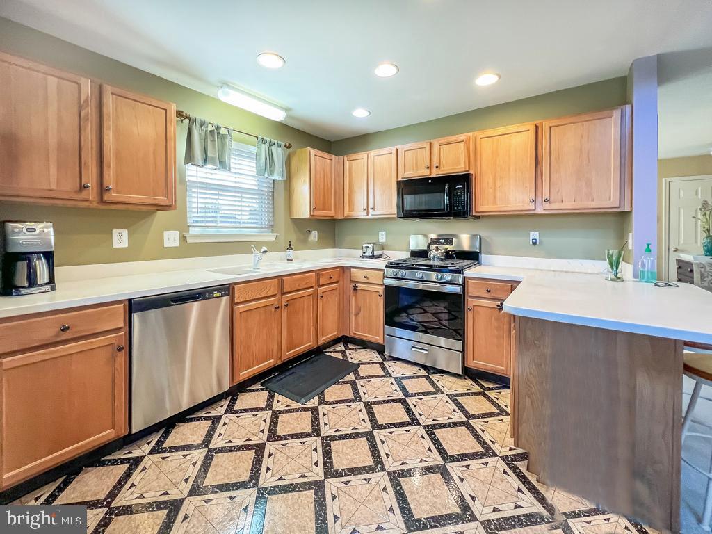 201 Raintree Crossing Hatfield, PA 19440 - Photo 21 of 46 a kitchen with a sink a stove a refrigerator cabinets and a window