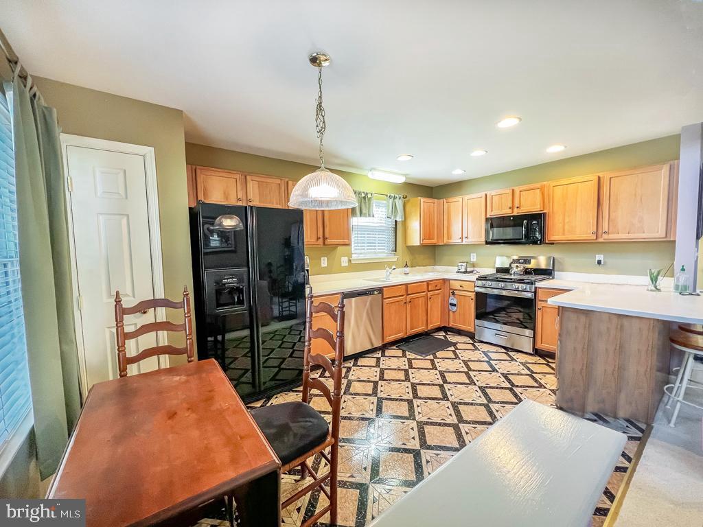 201 Raintree Crossing Hatfield, PA 19440 - Photo 25 of 46 a kitchen with stainless steel appliances kitchen island granite countertop a refrigerator a stove top oven and a sink with cabinets