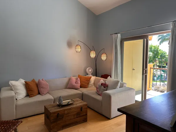 a close view of a refrigerator in kitchen and an empty kitchen with wooden floor