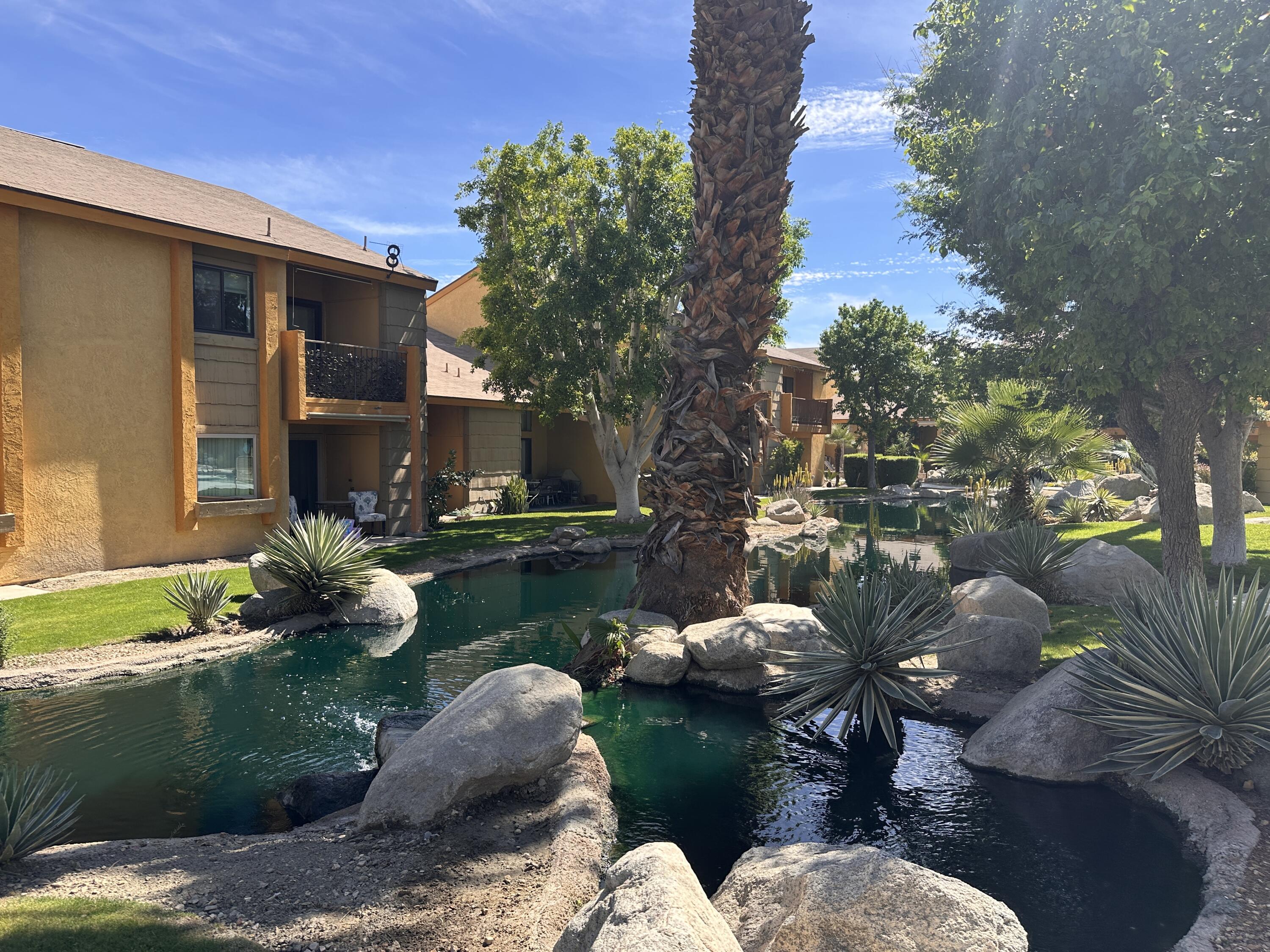 48255 Monroe Street, Unit 5 Indio, CA 92201 - Photo 2 of 57 a backyard of a house with lots of green space