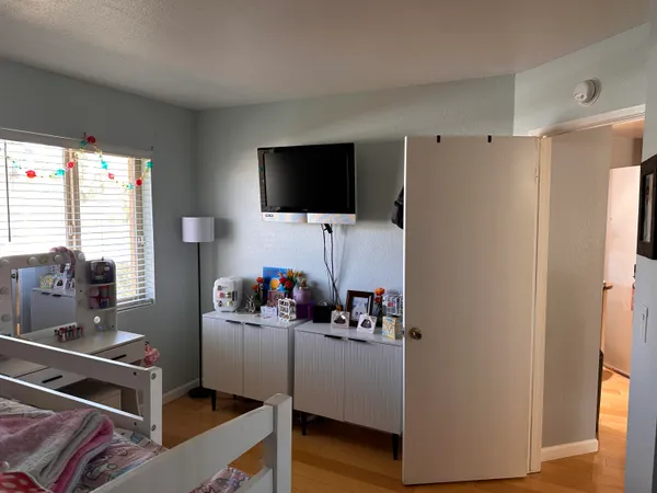 a bedroom with a bed and a flat screen tv