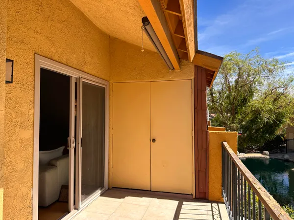 a front view of a house with garden space and lake view