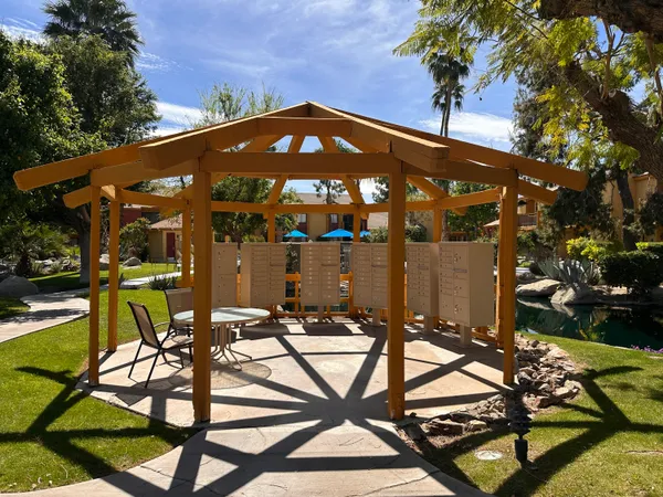 a front view of a house with swimming pool and outdoor seating