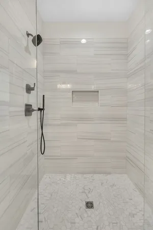 a bathroom with a tub and shower