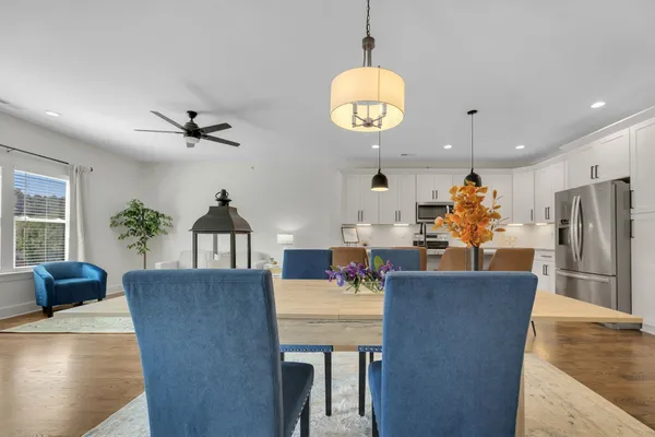 a kitchen with stainless steel appliances granite countertop a sink a stove and white cabinets