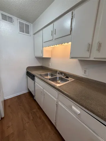 a kitchen that has a sink and a stove