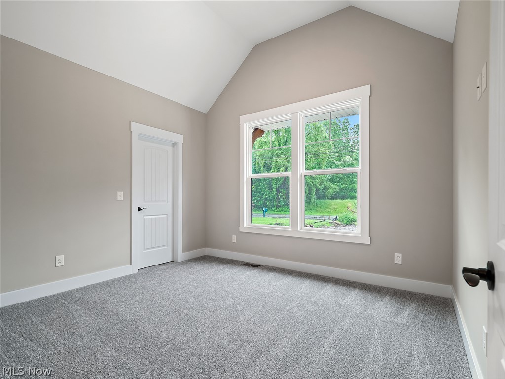 32 Brookside Lane North Ridgeville, OH 44039 - Photo 13 of 50 Carpeted spare room with vaulted ceiling