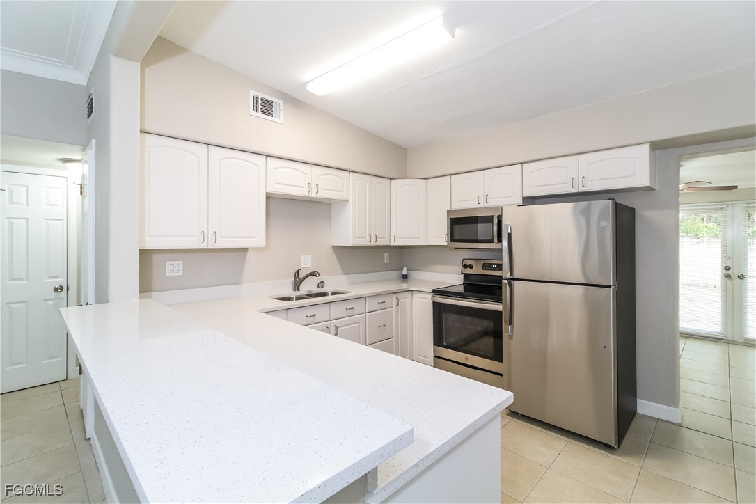 315 Ginger Road Venice, FL 34293 - Photo 5 of 16 a kitchen with stainless steel appliances a refrigerator sink and stove