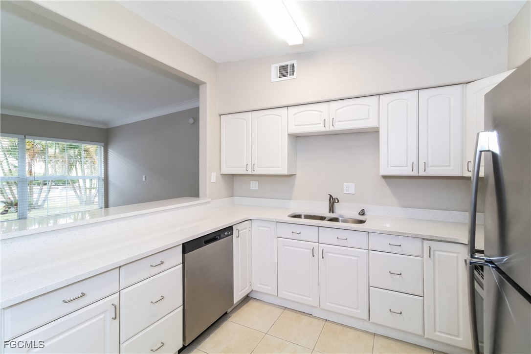 315 Ginger Road Venice, FL 34293 - Photo 6 of 16 a kitchen with white cabinets and white appliances