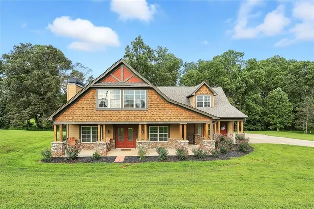 a front view of a house with a garden