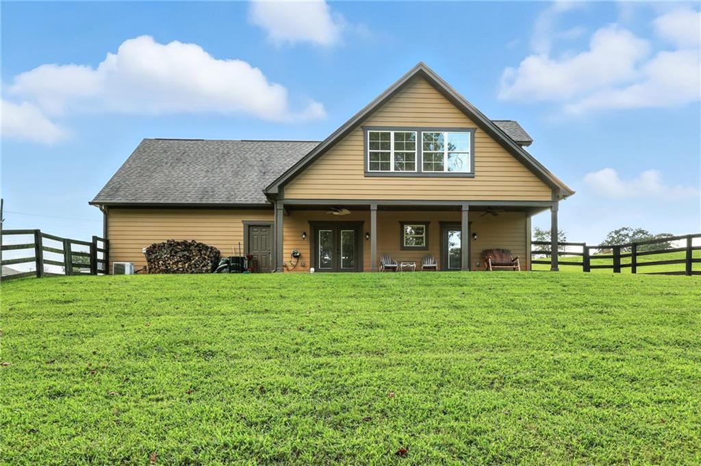 5911 Bent Tree Way Clermont, GA 30527 - Photo 11 of 56 a front view of a house with a garden
