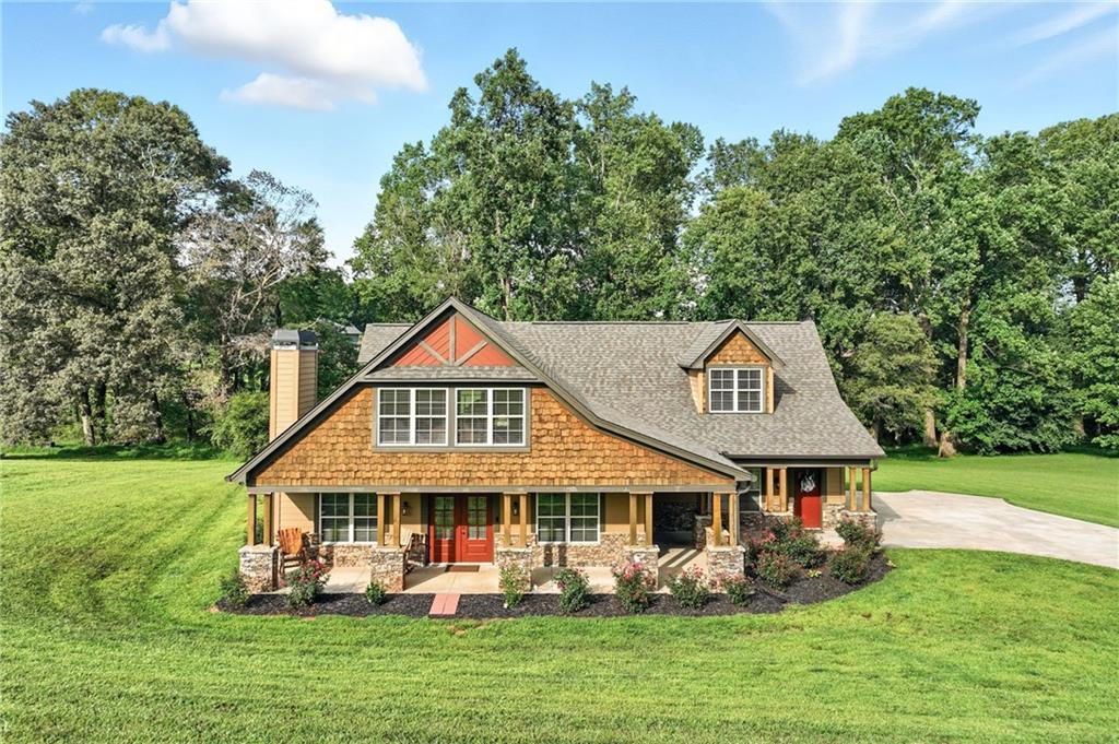 5911 Bent Tree Way Clermont, GA 30527 - Photo 13 of 56 a front view of a house with garden