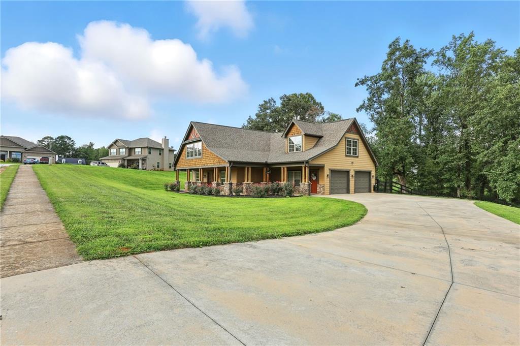 5911 Bent Tree Way Clermont, GA 30527 - Photo 2 of 56 a view of house with garden