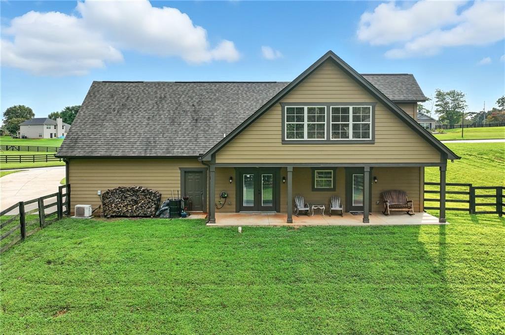 5911 Bent Tree Way Clermont, GA 30527 - Photo 22 of 56 a front view of a house with garden and a fountain
