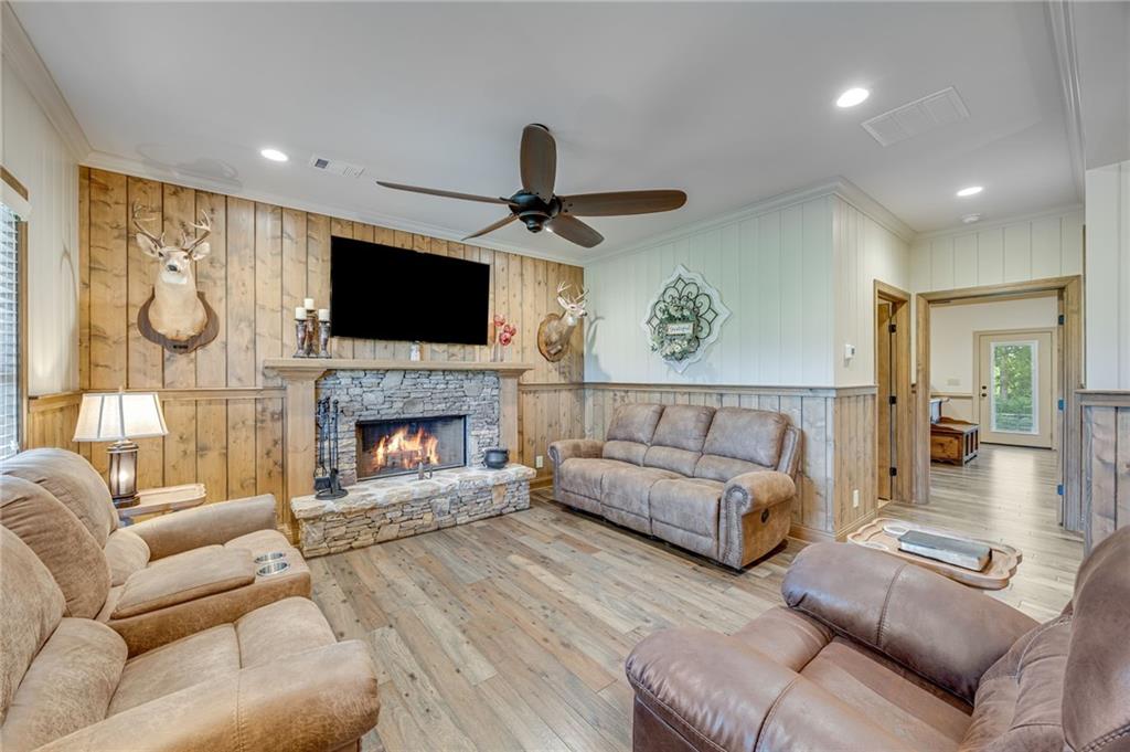 5911 Bent Tree Way Clermont, GA 30527 - Photo 27 of 56 a living room with furniture a flat screen tv and a fireplace