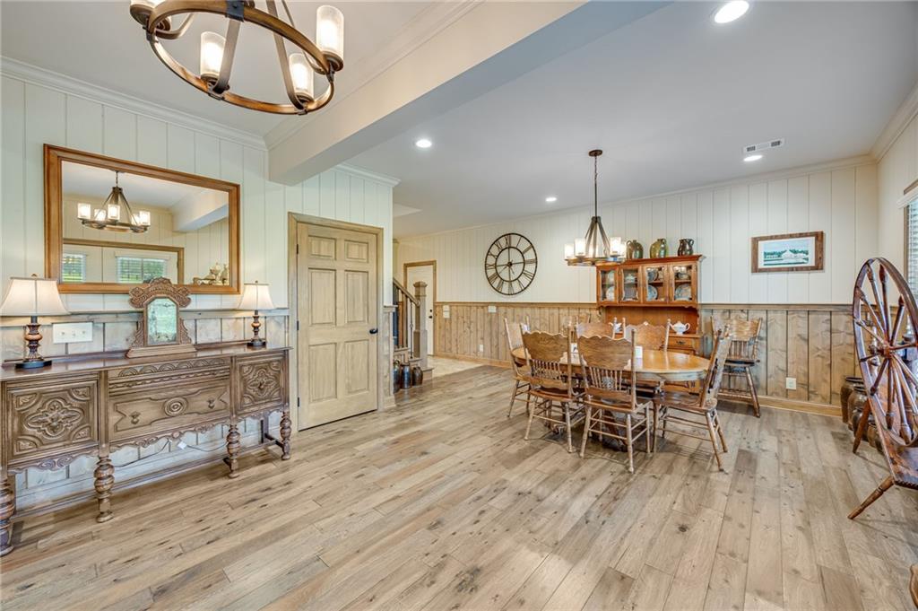 5911 Bent Tree Way Clermont, GA 30527 - Photo 29 of 56 a view of a dining room with furniture and wooden floor