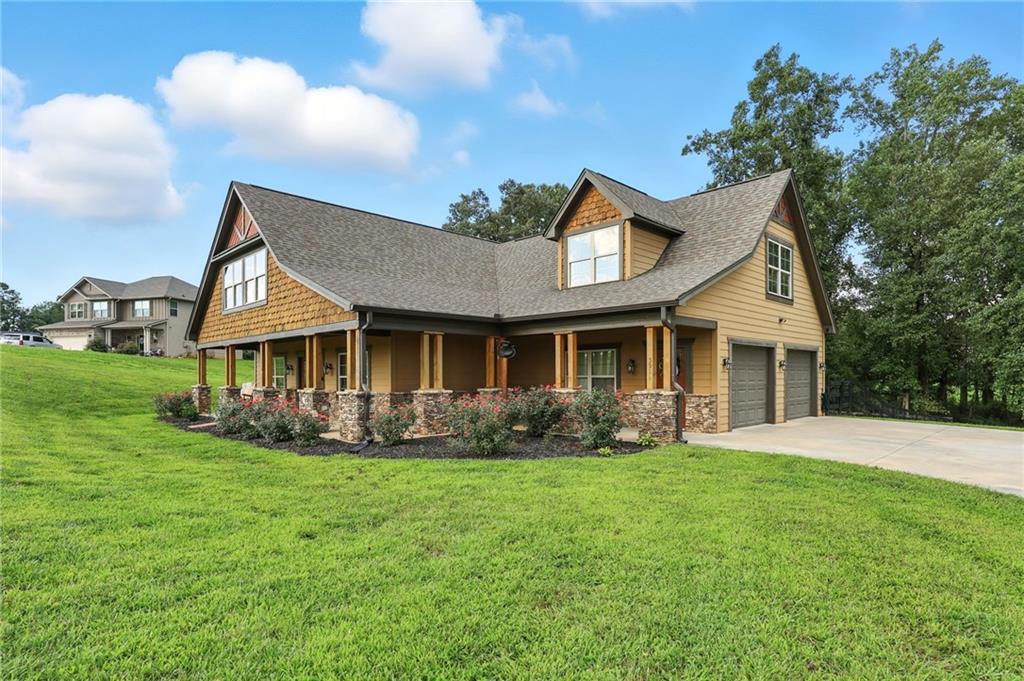 5911 Bent Tree Way Clermont, GA 30527 - Photo 3 of 56 a front view of a house with yard and porch