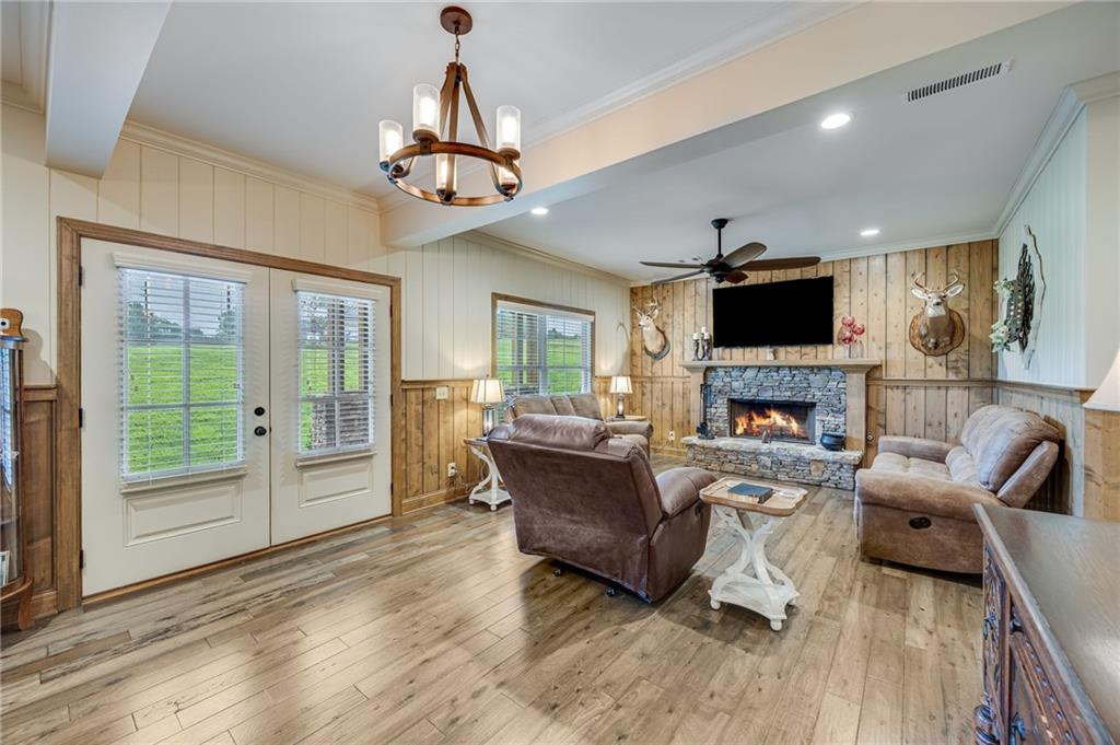 5911 Bent Tree Way Clermont, GA 30527 - Photo 31 of 56 a living room with furniture a fireplace and a flat screen tv