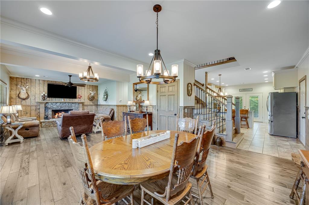 5911 Bent Tree Way Clermont, GA 30527 - Photo 32 of 56 a dining room with furniture a chandelier and wooden floor