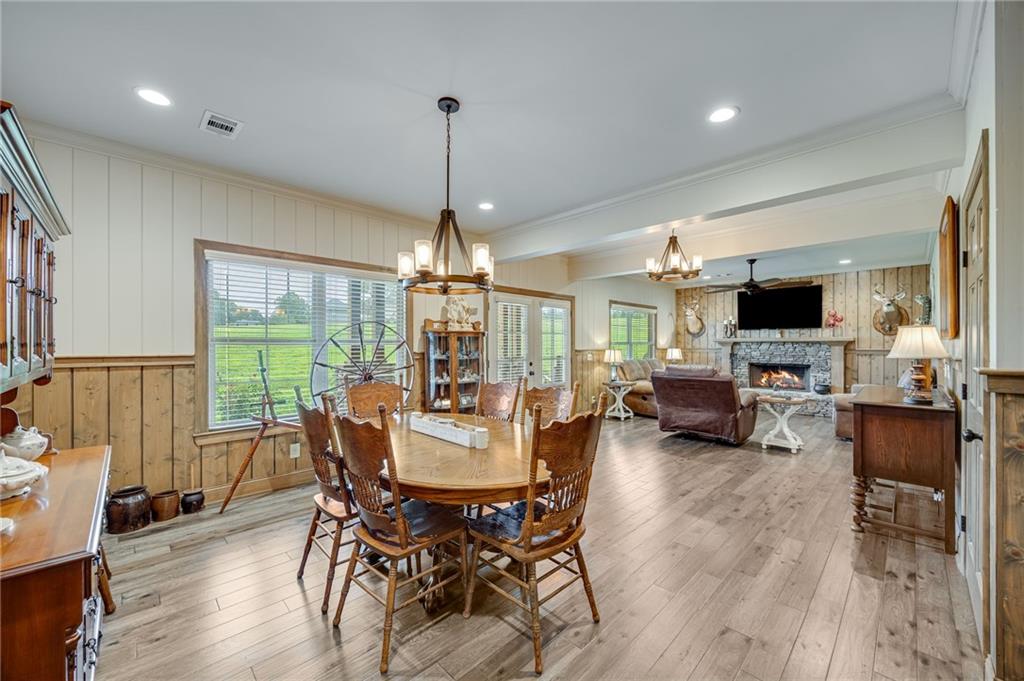 5911 Bent Tree Way Clermont, GA 30527 - Photo 33 of 56 a view of a dining room with furniture window and wooden floor