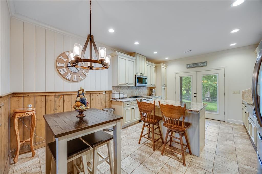 5911 Bent Tree Way Clermont, GA 30527 - Photo 34 of 56 a view of a dining room with furniture window and wooden floor