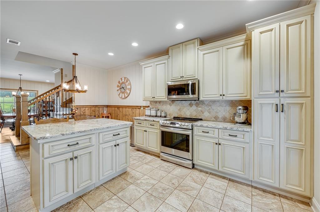 5911 Bent Tree Way Clermont, GA 30527 - Photo 37 of 56 a kitchen with white cabinets and appliances