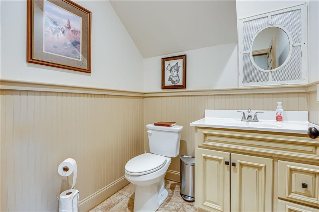 5911 Bent Tree Way Clermont, GA 30527 - Photo 38 of 56 a bathroom with a toilet a sink and mirror