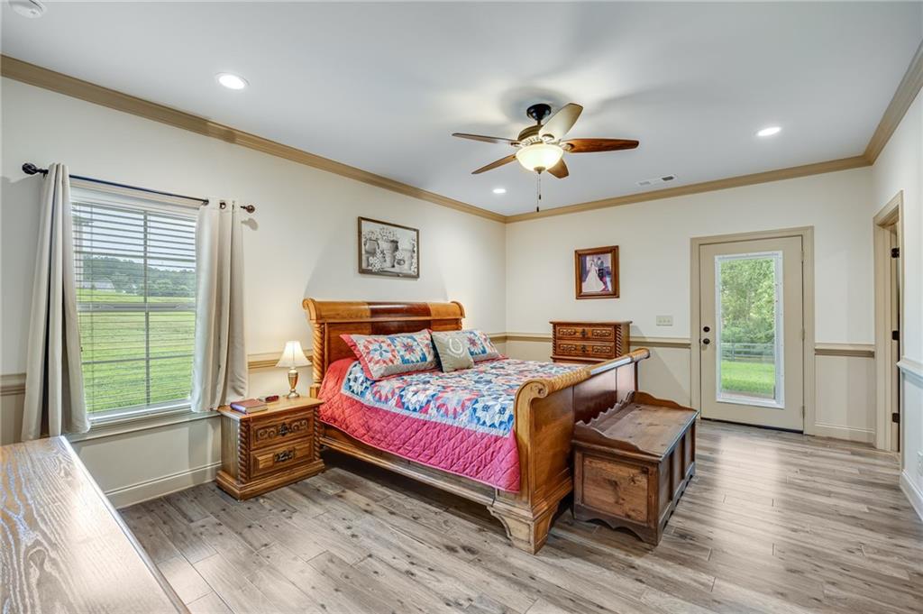 5911 Bent Tree Way Clermont, GA 30527 - Photo 40 of 56 a bedroom with a bed and wooden floor