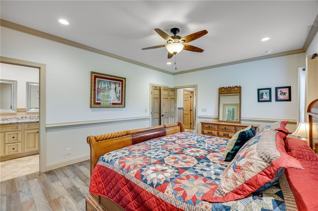 5911 Bent Tree Way Clermont, GA 30527 - Photo 41 of 56 a bedroom with a bed and wooden floor