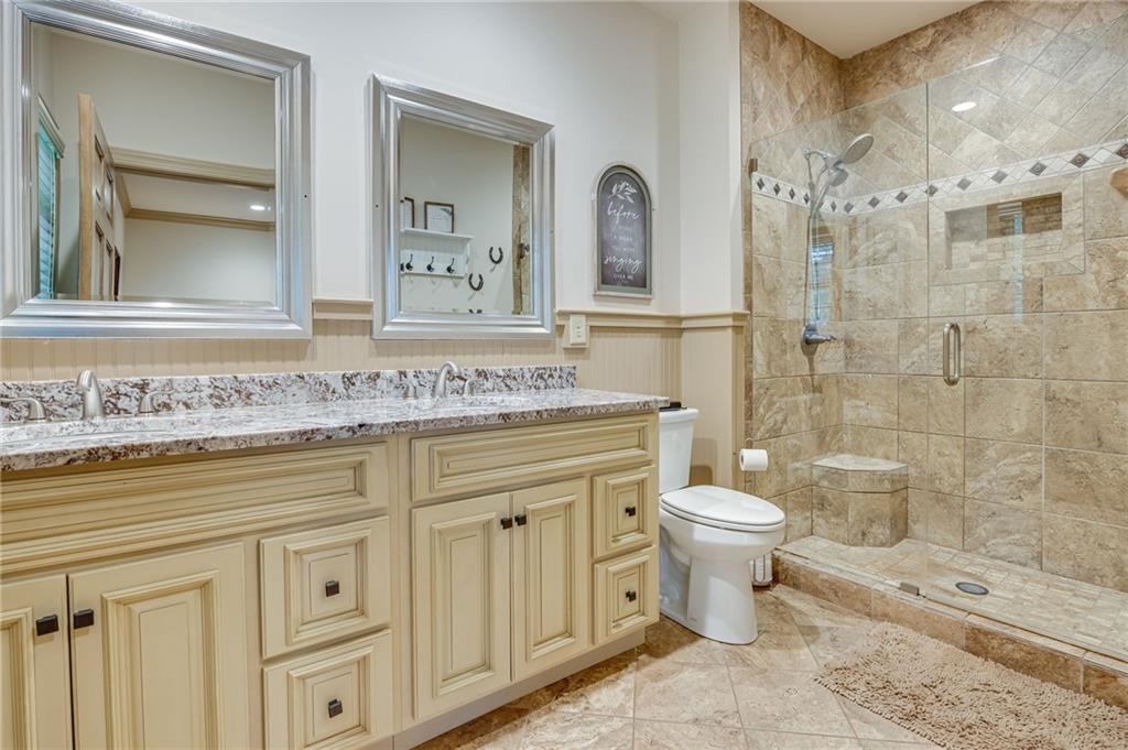 5911 Bent Tree Way Clermont, GA 30527 - Photo 42 of 56 a bathroom with a shower toilet sink and mirror